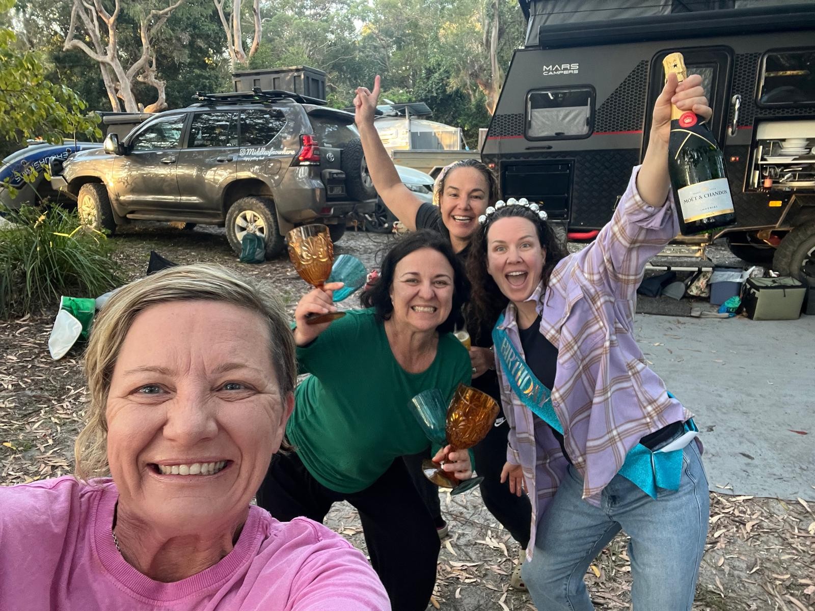 Caroline and friends celebrating at camp beside the Mars 15 at Station Creek